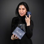 Woman holding two blue jewelry boxes with 'Eclectic1984' branding against a dark background